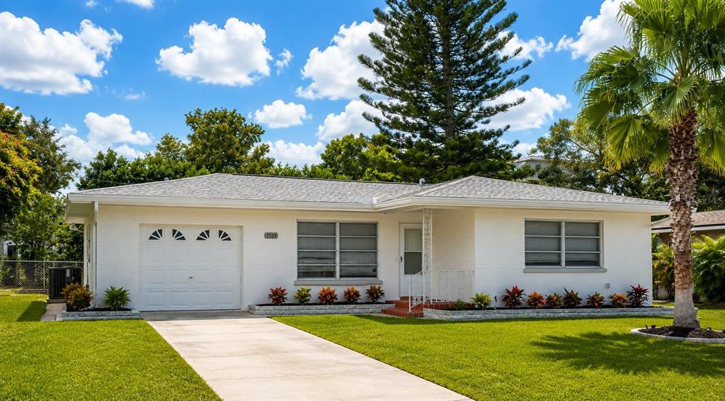 1559 Barry Road Clearwater, FL 33756 - Photo 2 of 20 a front view of a house with a yard