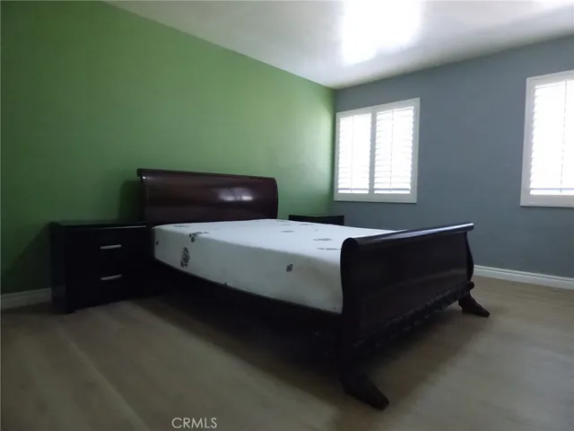 a bed sitting in a bedroom next to a window