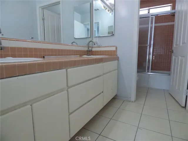 a bathroom with a glass shower door