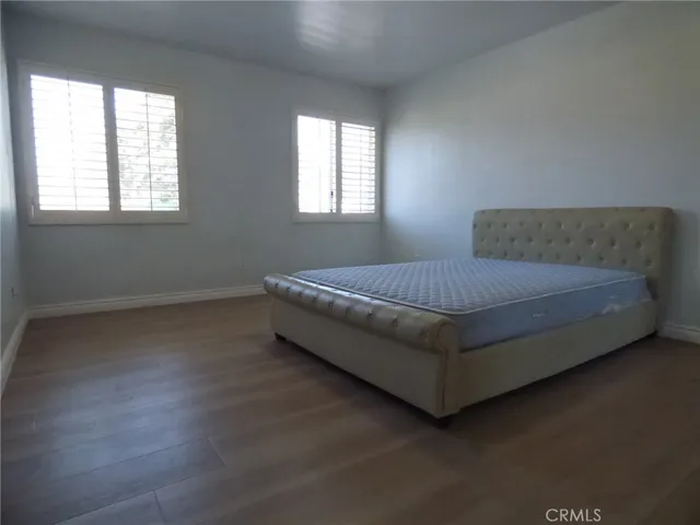 a spacious bedroom with a bed and a chandelier