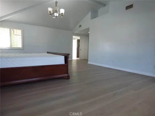a bathroom with a granite countertop sink a large mirror and a bathtub
