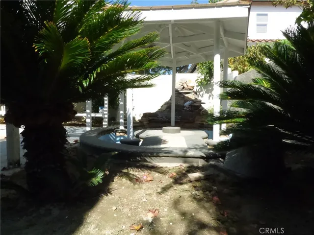 a backyard of a house with table and chairs