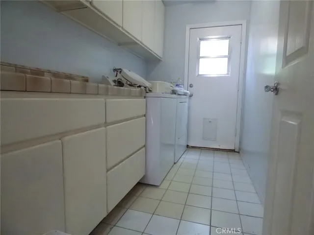 a view of a kitchen with white cabinets