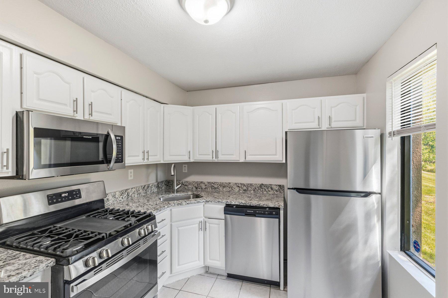 5866 Thunder Hill Road, Unit A4 Columbia, MD 21045 - Photo 2 of 21 Kitchen with brand-new appliances and a countertop