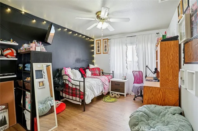 a bedroom with bed and a chandelier