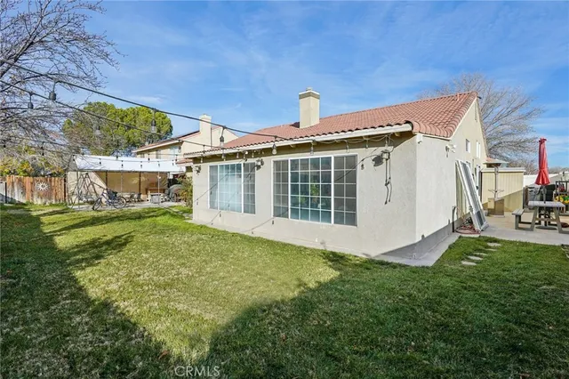 a view of a house with a yard and sitting area
