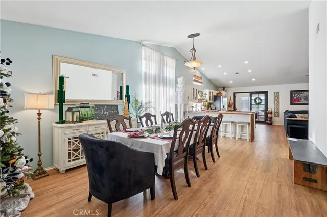 a dining room with furniture window and wooden floor