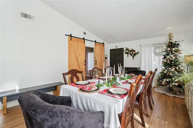 a view of a dining room with furniture window and wooden floor