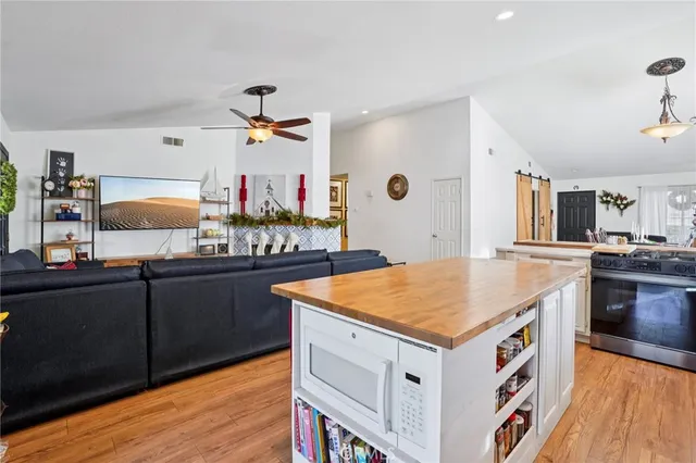 a kitchen with stainless steel appliances granite countertop a sink and cabinets