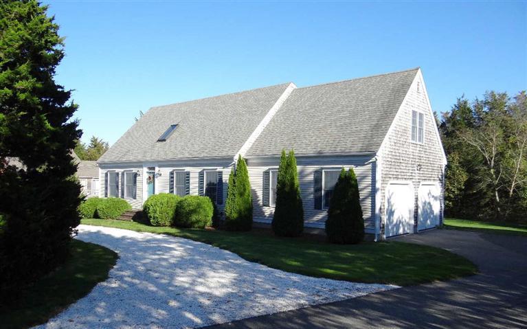 28 Seavers Road Orleans, MA 02653 - Photo 2 of 16 a view of a house with brick walls plants and palm trees