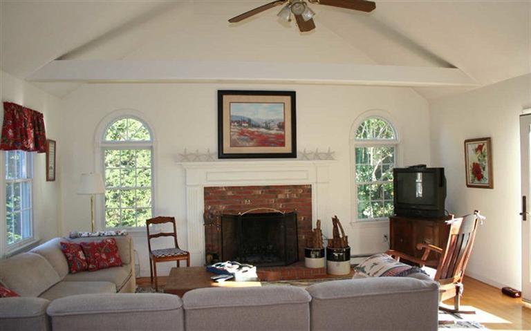 28 Seavers Road Orleans, MA 02653 - Photo 3 of 16 a living room with furniture and a fireplace