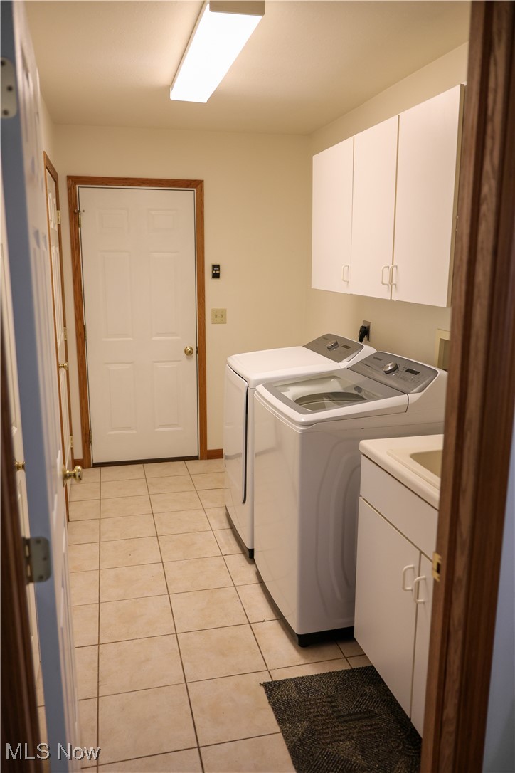 2003 East County Line Road Mineral Ridge, OH 44440 - Photo 29 of 33 Laundry room featuring light tile patterned flooring, cabinet space, and washer and dryer