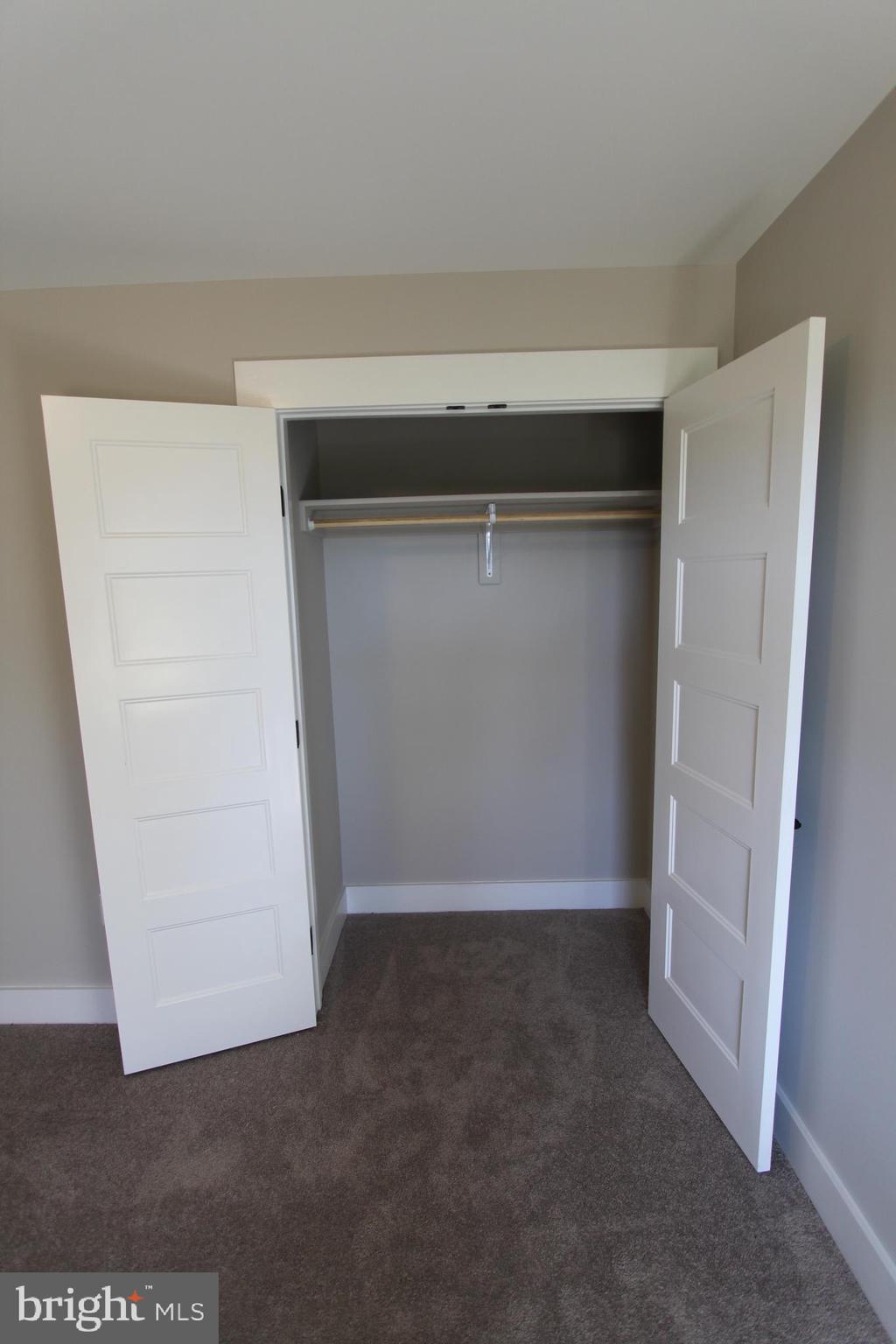 28049 Strawberry Hill Road Rhoadesville, VA 22542 - Photo 28 of 32 Bedroom 3 closet with wood shelf and rod.