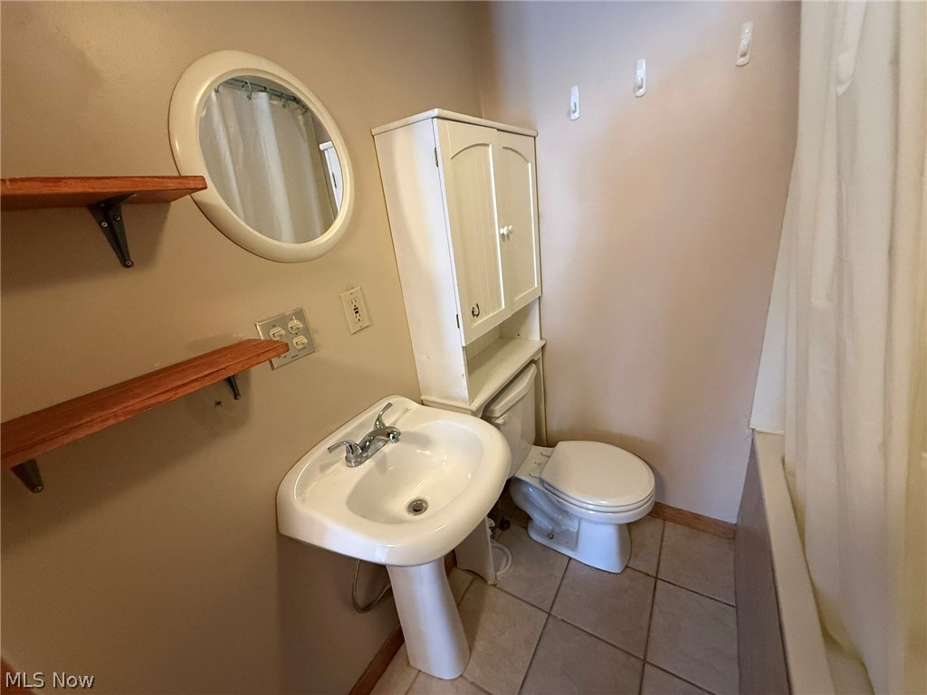 6784 Old Zoarville Road Northeast Dover, OH 44622 - Photo 33 of 50 Bathroom with light tile patterned flooring and shower / bath combo