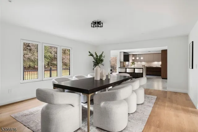 a kitchen with a sink and chairs