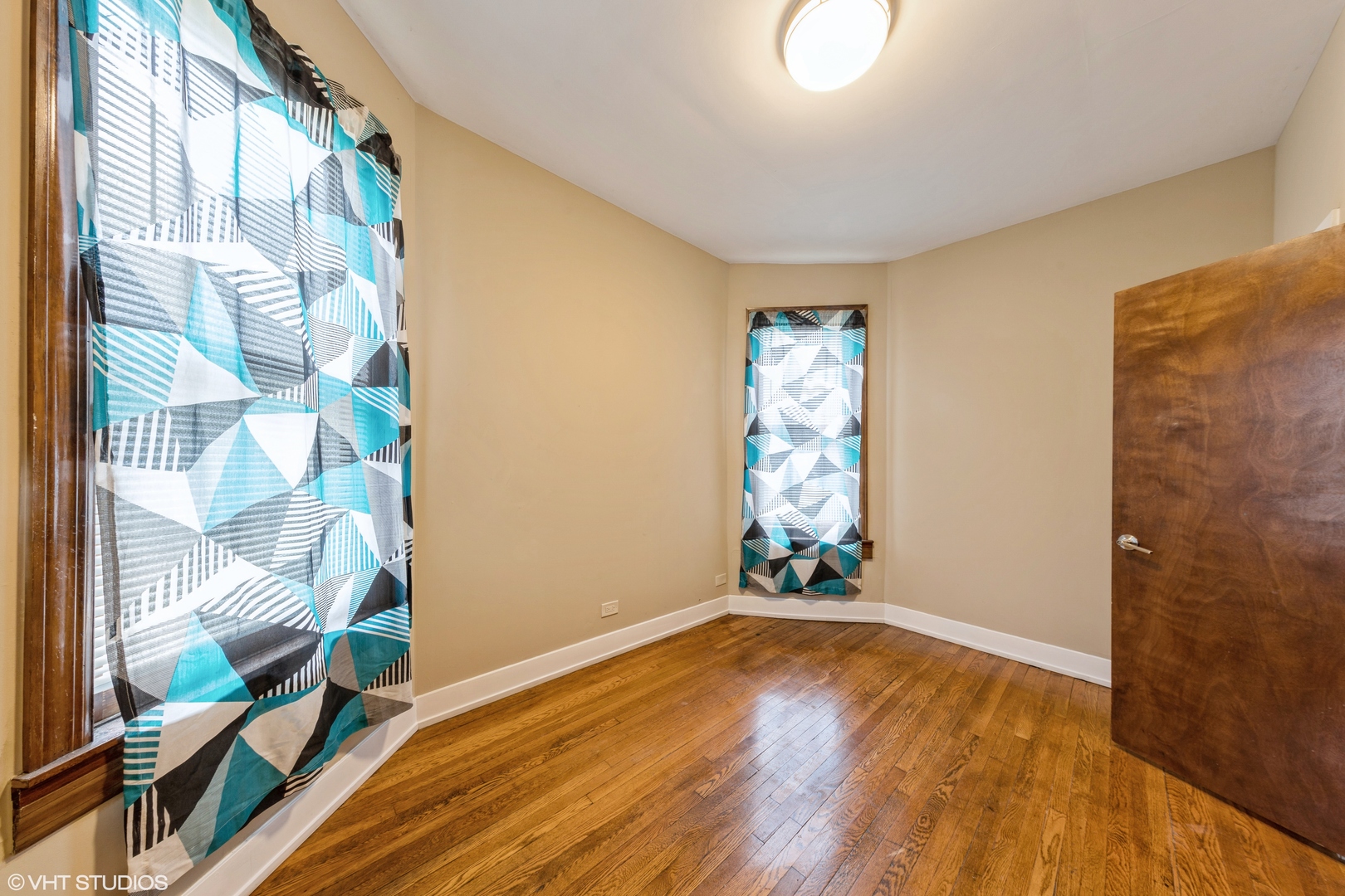 7806 South May Street Chicago, IL 60620 - Photo 11 of 20 a view of an empty room with wooden floor and a window