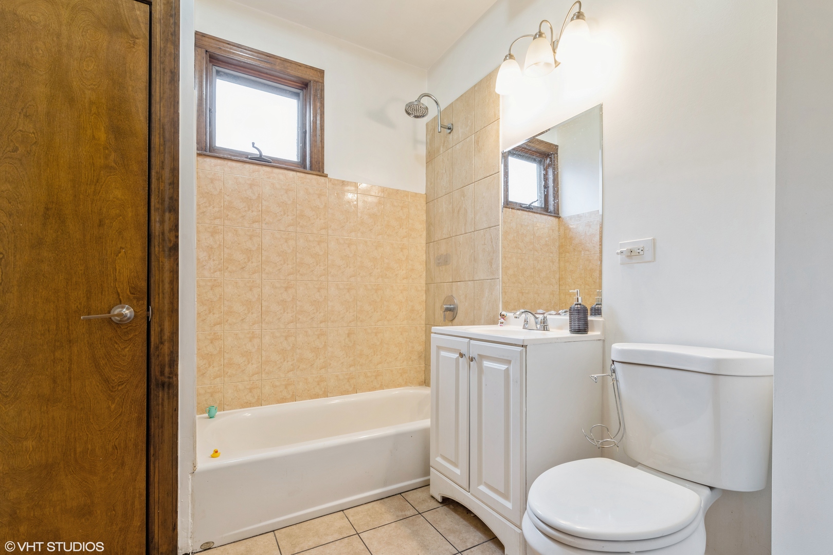 7806 South May Street Chicago, IL 60620 - Photo 13 of 20 a white toilet sitting next to a bath tub