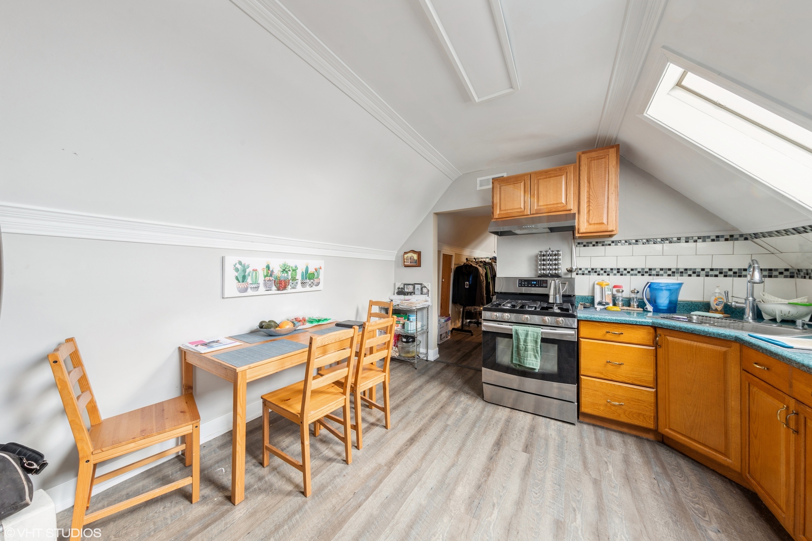 7806 South May Street Chicago, IL 60620 - Photo 15 of 20 a kitchen with stainless steel appliances granite countertop a stove top oven a sink dishwasher and white cabinets with wooden floor