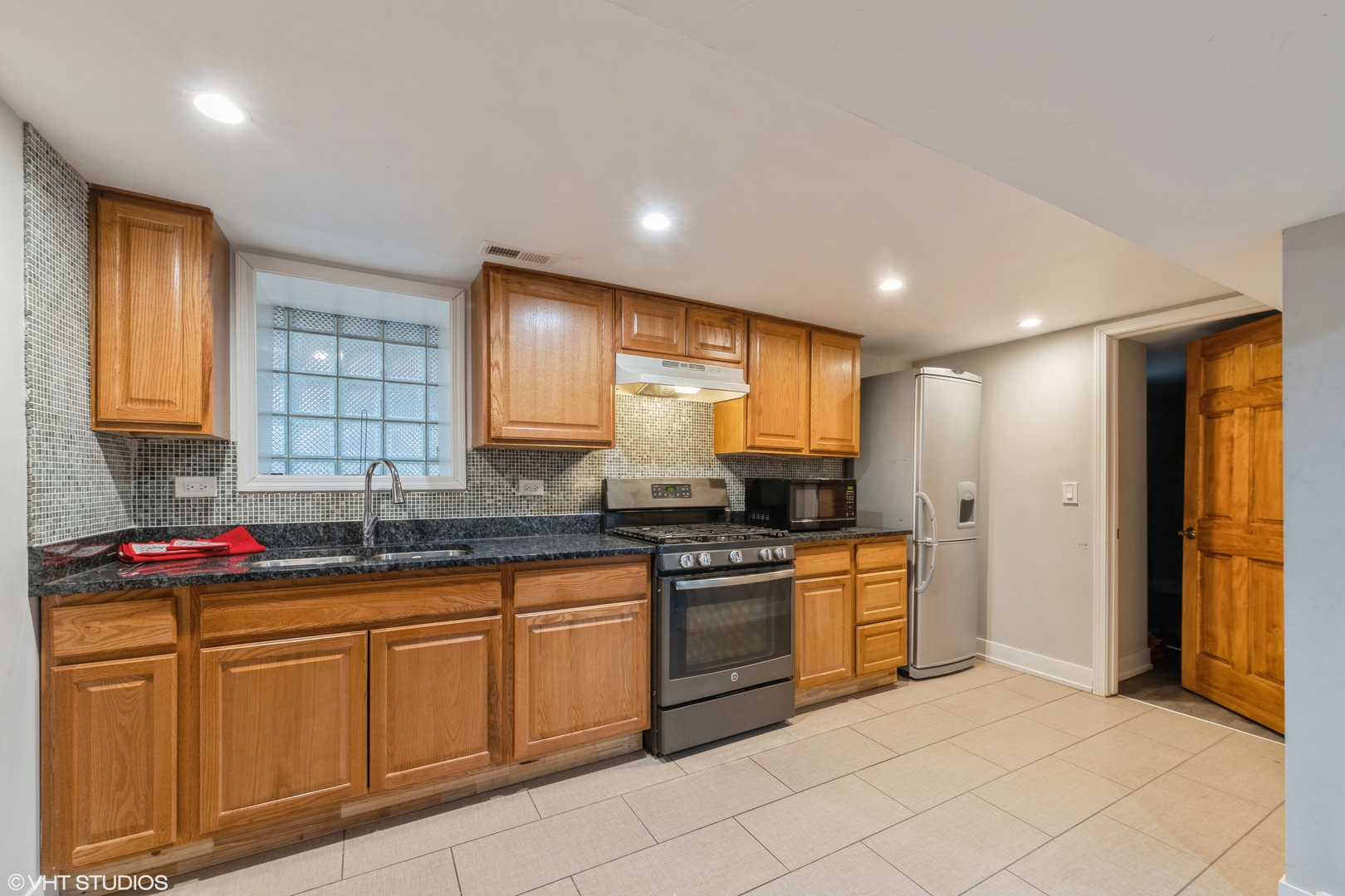 7806 South May Street Chicago, IL 60620 - Photo 3 of 20 a kitchen with stainless steel appliances granite countertop a sink and cabinets