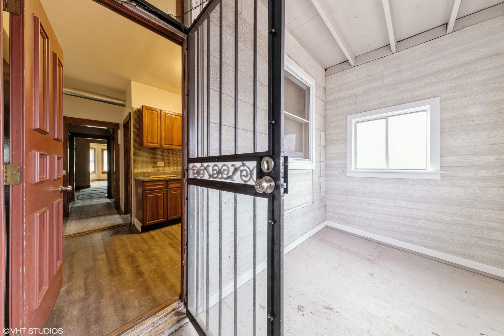 7806 South May Street Chicago, IL 60620 - Photo 6 of 20 a view of a hallway with wooden floor and entryway