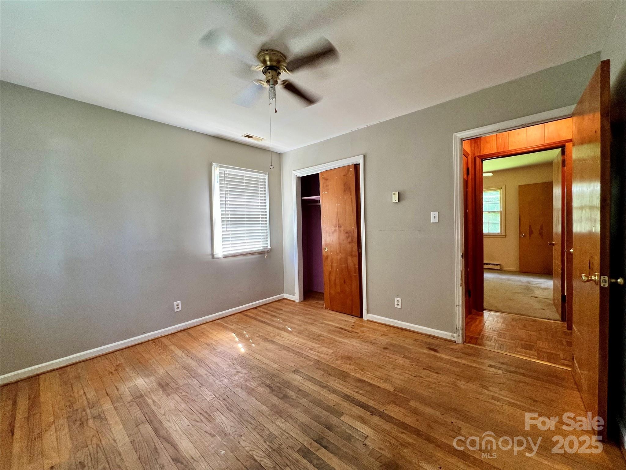 1321 Stallings Road Matthews, NC 28104 - Photo 5 of 11 a view of empty room with wooden floor and fan