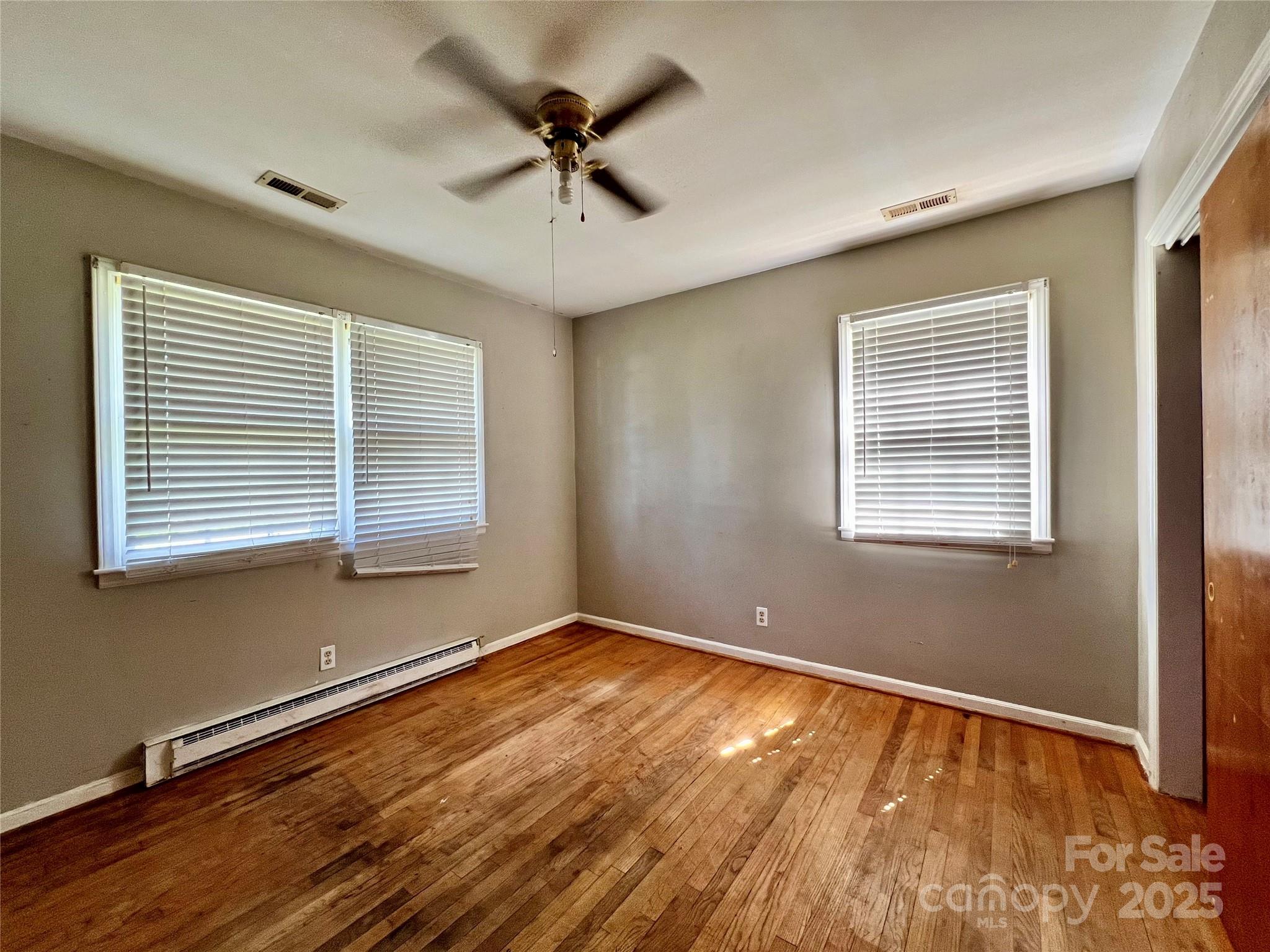 1321 Stallings Road Matthews, NC 28104 - Photo 6 of 11 a view of an empty room with a window and wooden floor