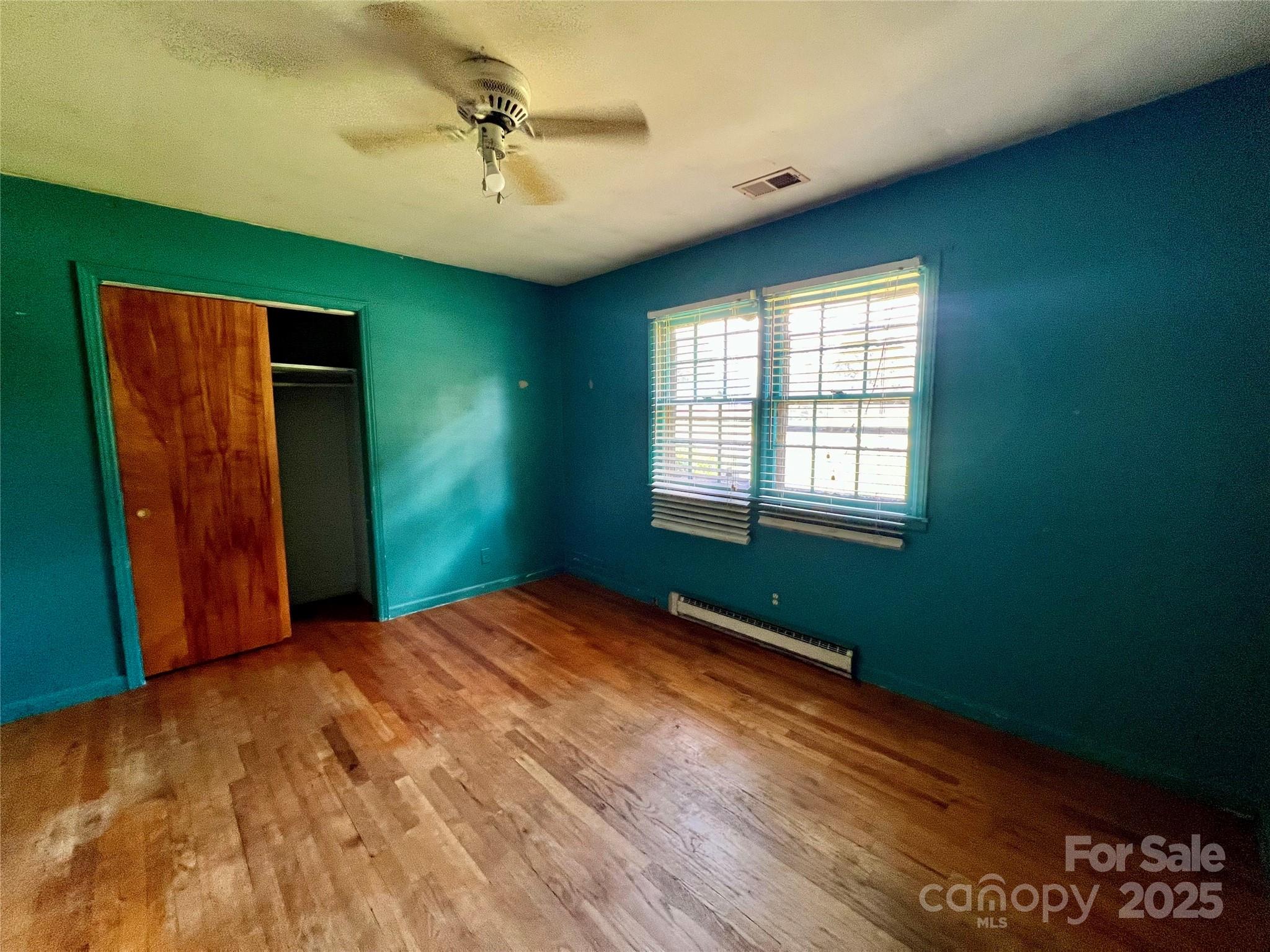 1321 Stallings Road Matthews, NC 28104 - Photo 9 of 11 a view of a room with window ceiling fan and hardwood floor