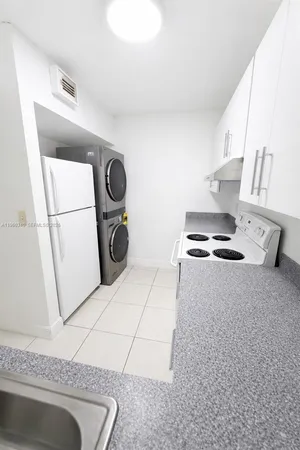 a stove top oven sitting inside of a kitchen