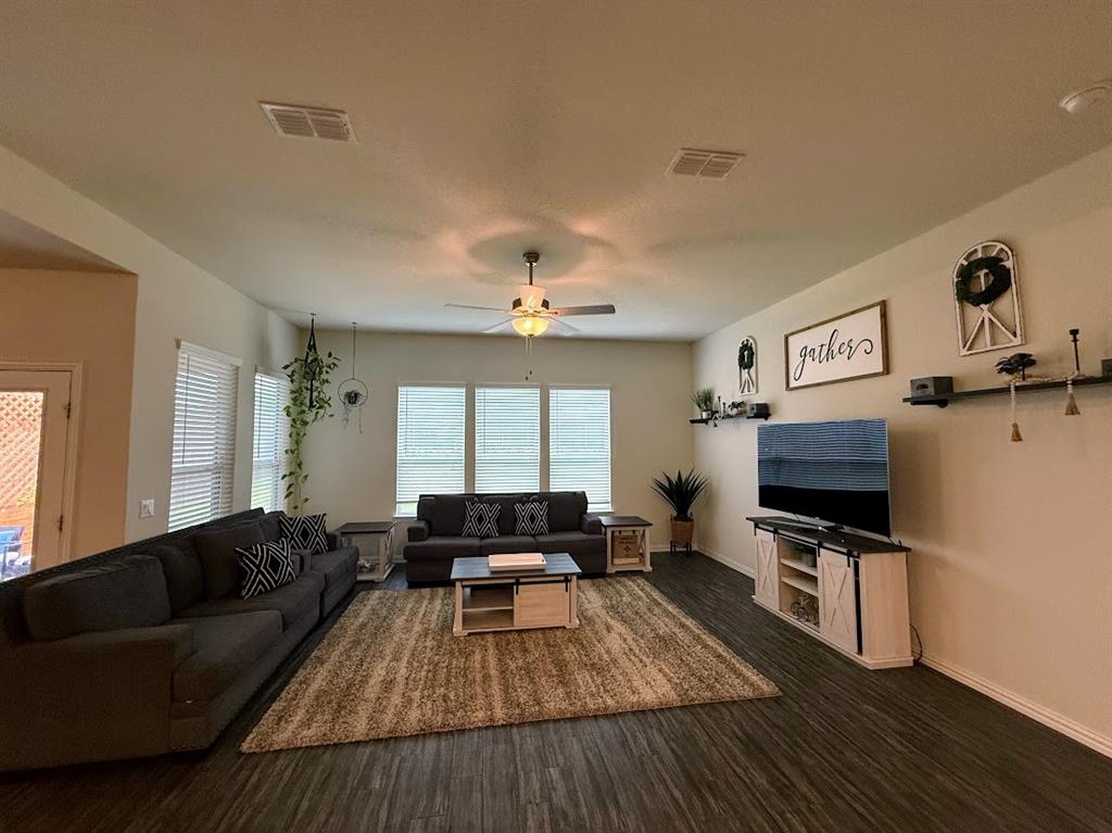1109 Pinnacle Ridge Road Fort Worth, TX 76052 - Photo 11 of 40 a living room with furniture and a flat screen tv