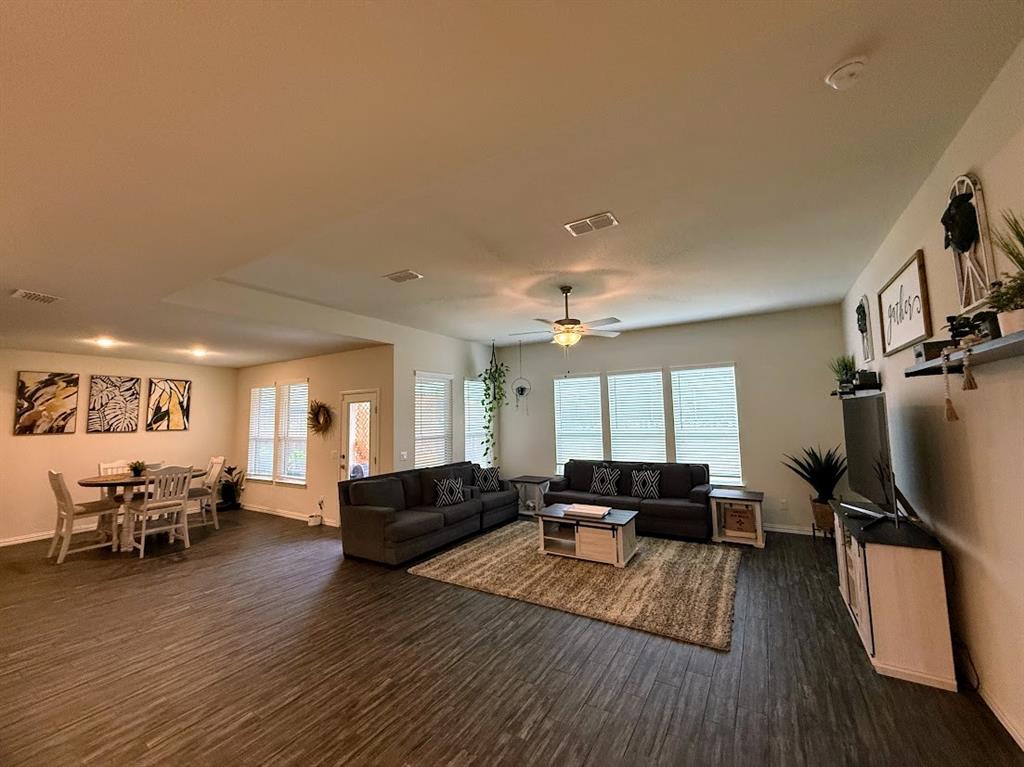 1109 Pinnacle Ridge Road Fort Worth, TX 76052 - Photo 12 of 40 a living room with furniture and a flat screen tv