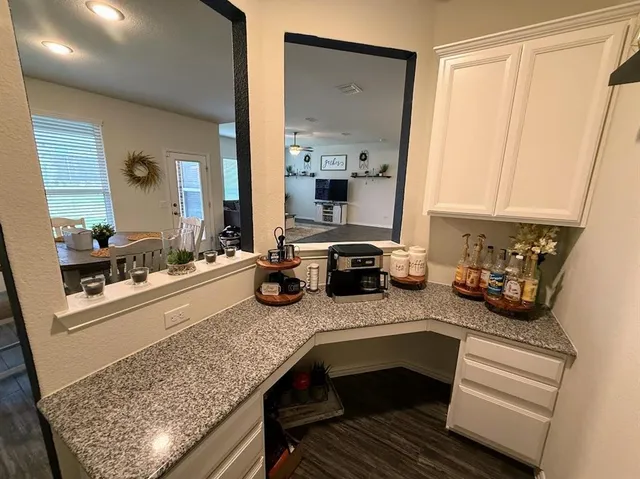 a kitchen with sink a stove and cabinets