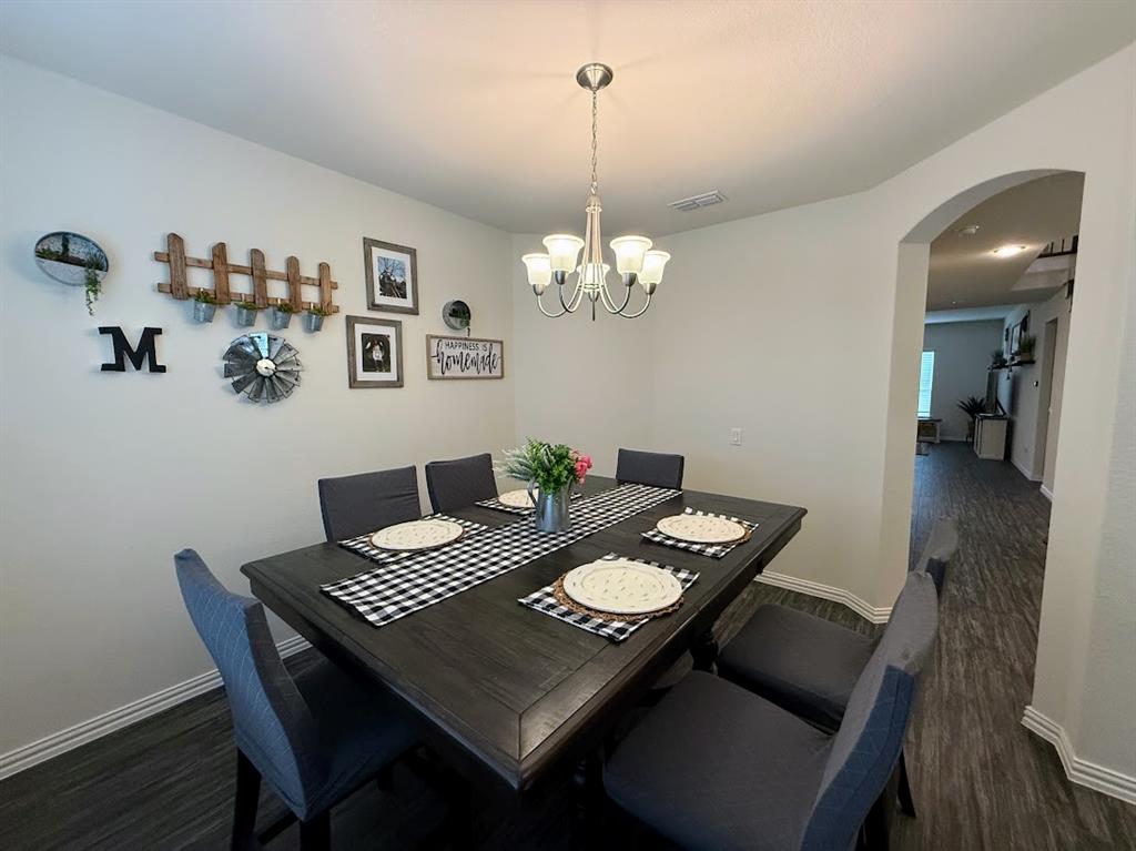 1109 Pinnacle Ridge Road Fort Worth, TX 76052 - Photo 20 of 40 a view of a dining room with furniture and wooden floor