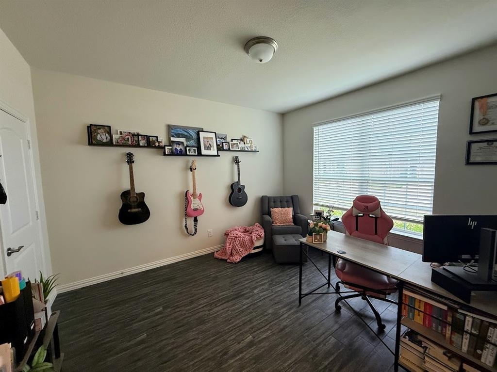 1109 Pinnacle Ridge Road Fort Worth, TX 76052 - Photo 22 of 40 a living room with furniture and a wooden floor