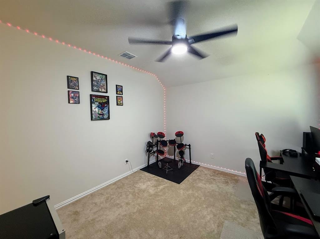 1109 Pinnacle Ridge Road Fort Worth, TX 76052 - Photo 32 of 40 a bedroom with a bed and furniture