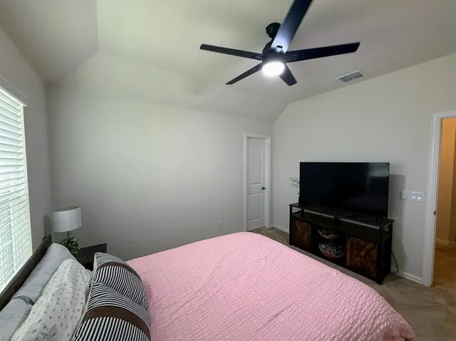 a bedroom with a bed and a flat screen tv