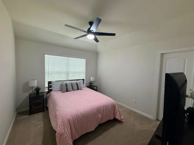 a bedroom with a bed and window