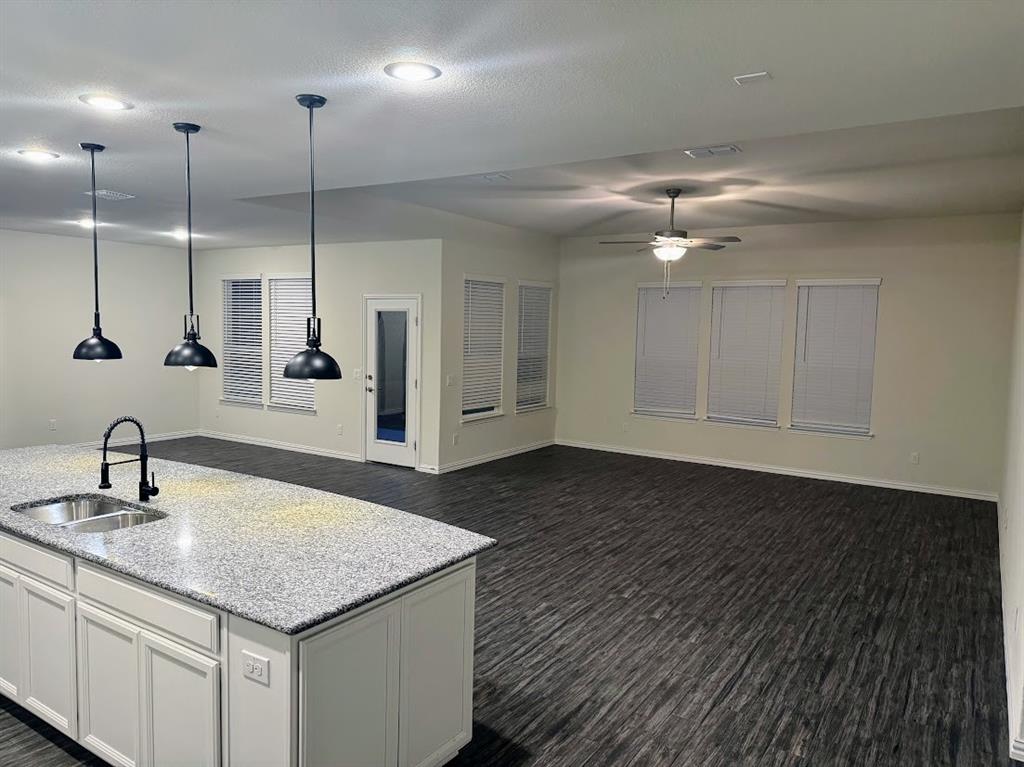 1109 Pinnacle Ridge Road Fort Worth, TX 76052 - Photo 40 of 40 a kitchen with a sink chandelier and wooden floor