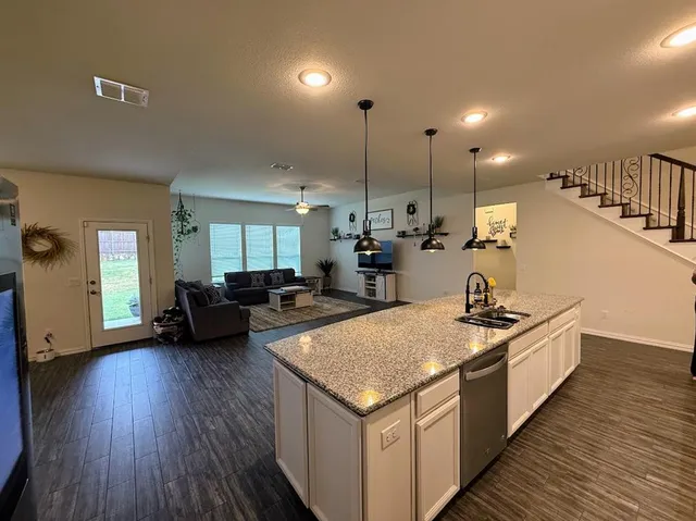 a kitchen with sink stove and cabinets