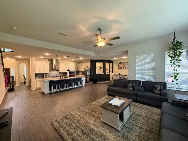 a living room with furniture and a chandelier