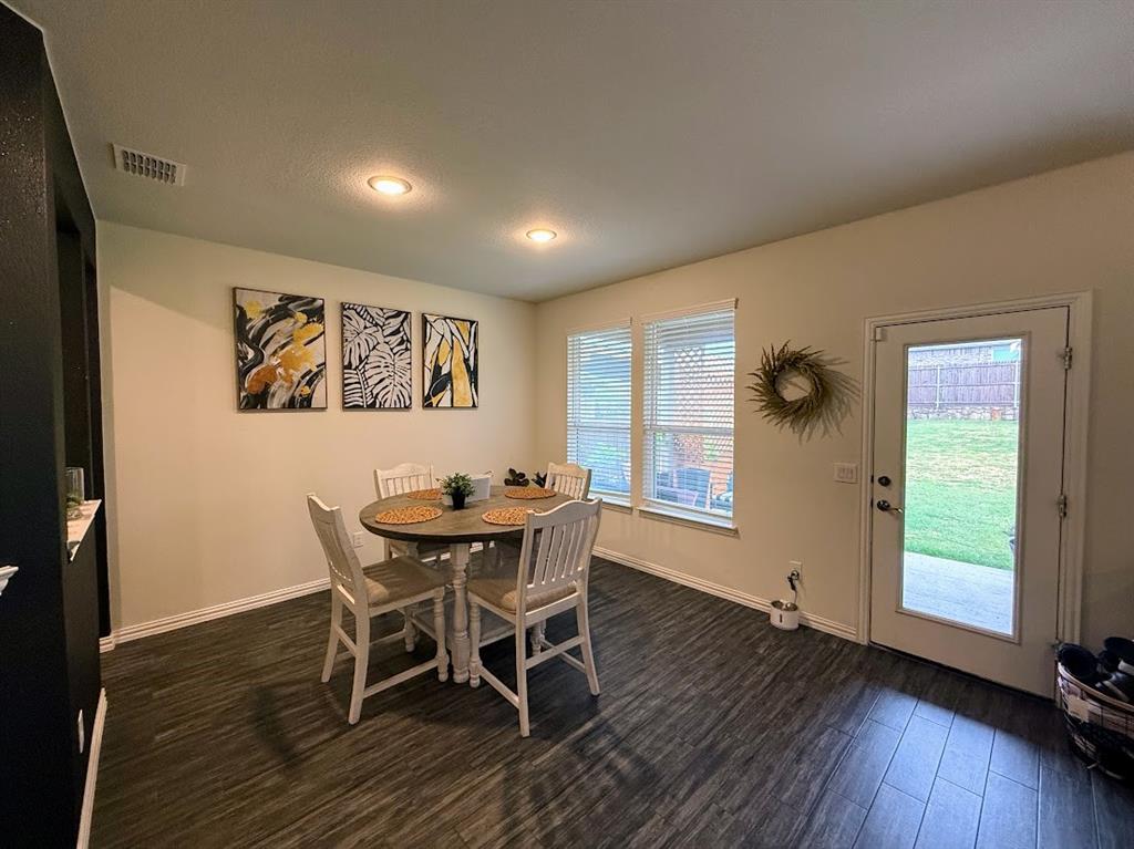 1109 Pinnacle Ridge Road Fort Worth, TX 76052 - Photo 10 of 40 a view of a dining room with furniture and wooden floor