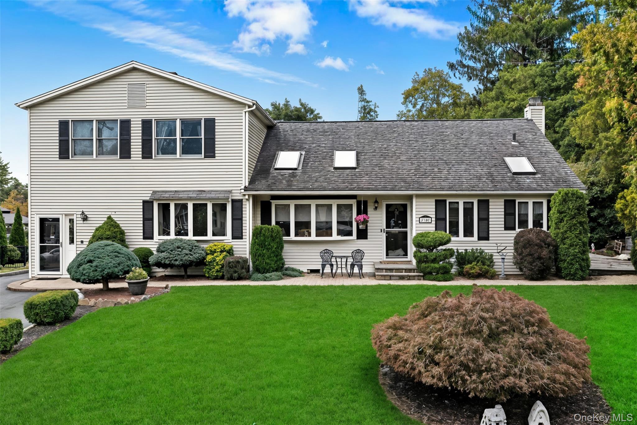 2747 Larkspur Street Yorktown Heights, NY 10598 - Photo 1 of 32 a front view of a house with a yard table and chairs