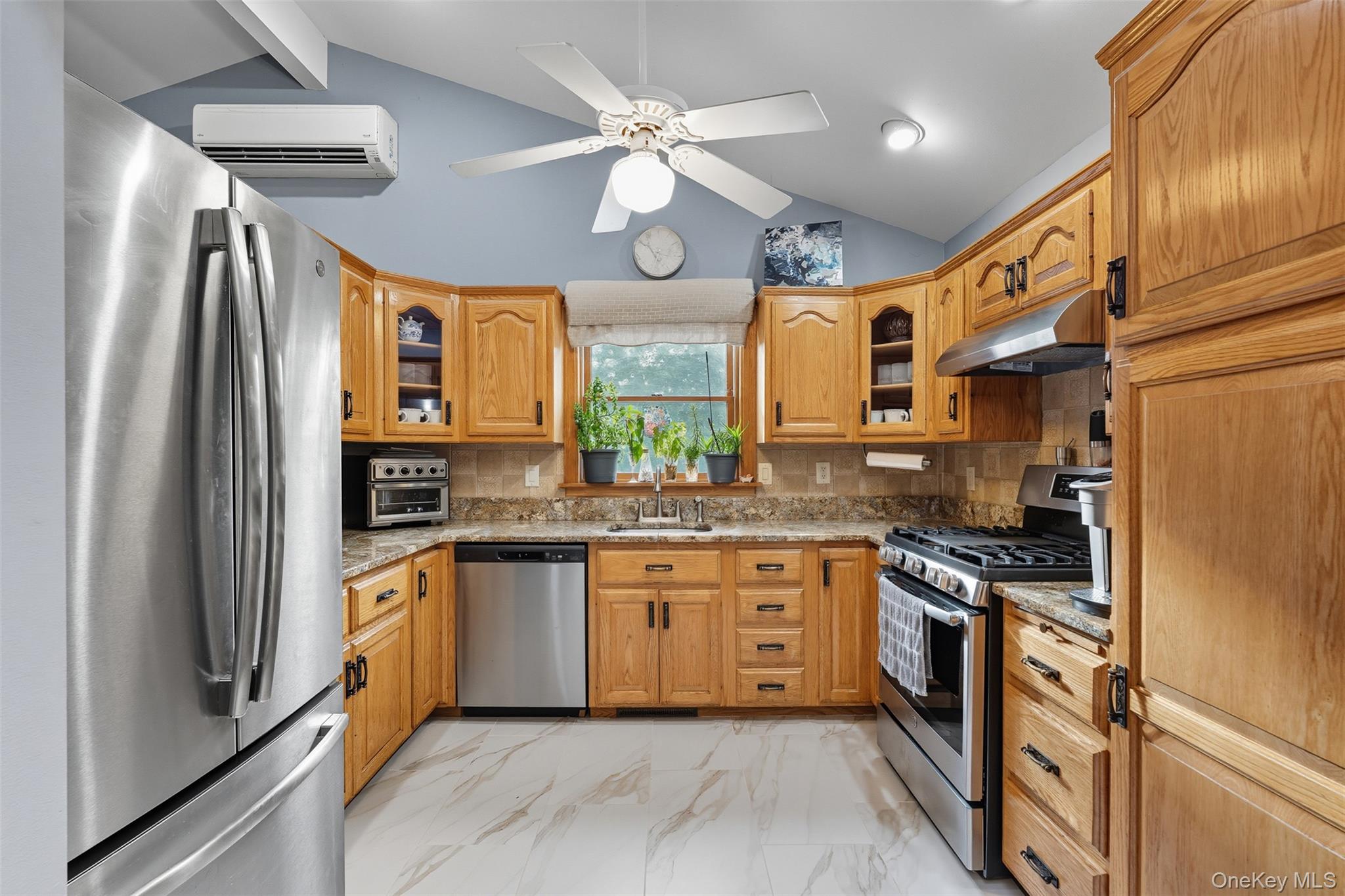 2747 Larkspur Street Yorktown Heights, NY 10598 - Photo 21 of 32 a kitchen with stainless steel appliances granite countertop a sink a stove and a refrigerator