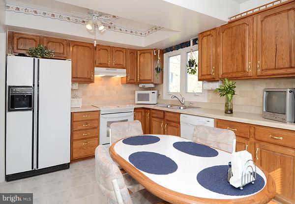 1202 Peachtree Road Fallston, MD 21047 - Photo 14 of 30 a kitchen with stainless steel appliances granite countertop a sink refrigerator and cabinets