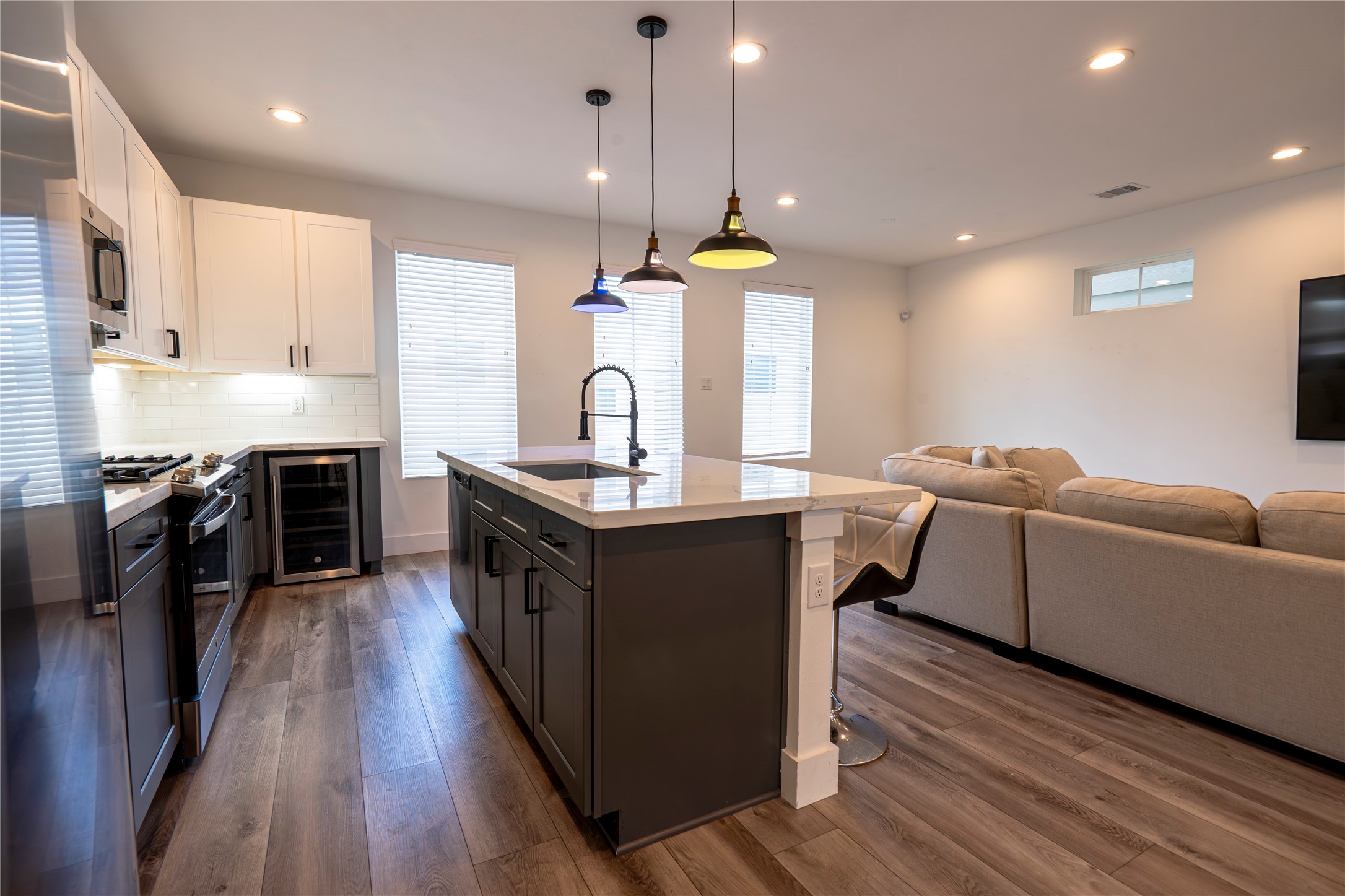 2056 Johanna Drive, Unit F Houston, TX 77055 - Photo 14 of 27 a kitchen with kitchen island granite countertop a sink a counter top space stainless steel appliances and a window