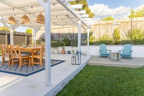 a view of a patio with table and chairs