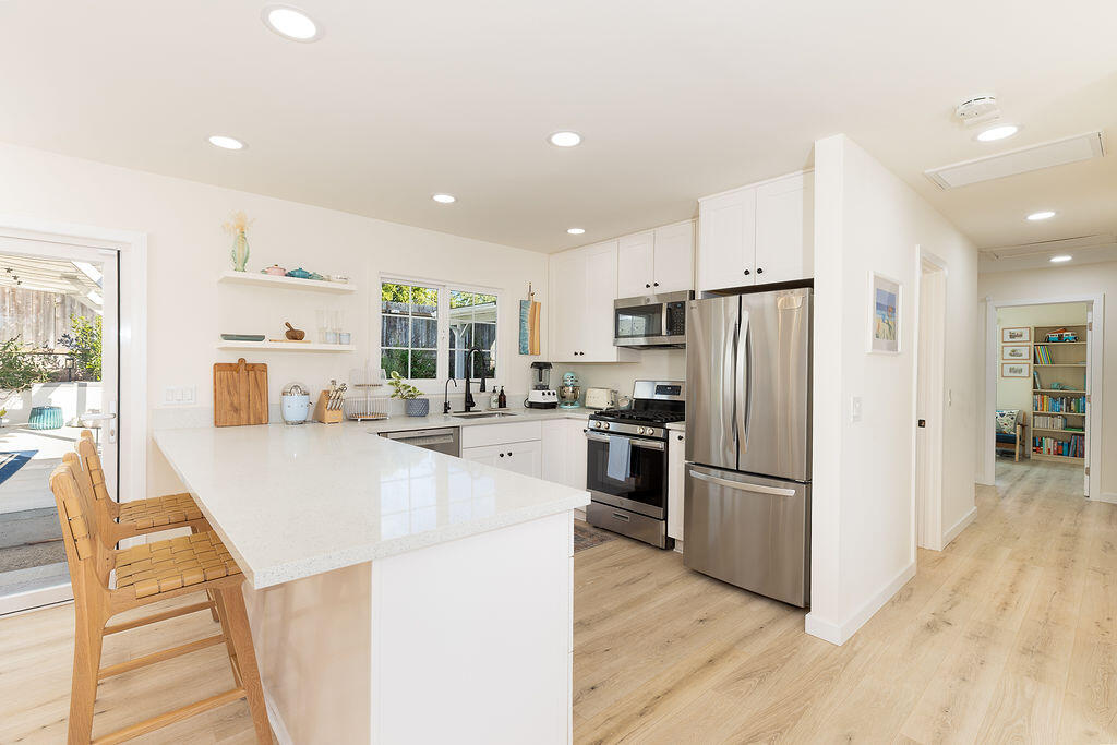 1430 Linhere Drive Carpinteria, CA 93013 - Photo 12 of 34 a kitchen with stainless steel appliances a refrigerator and a stove top oven