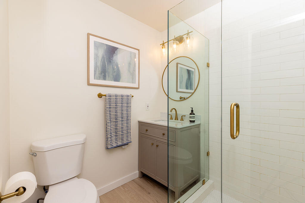 1430 Linhere Drive Carpinteria, CA 93013 - Photo 13 of 34 a bathroom with a toilet a sink and mirror