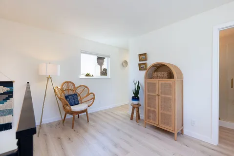 a living room with furniture a rug and wooden floor