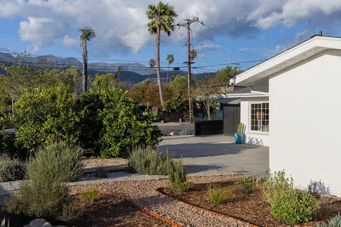 a front view of a house with garden