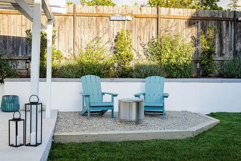 a view of two chairs in the patio